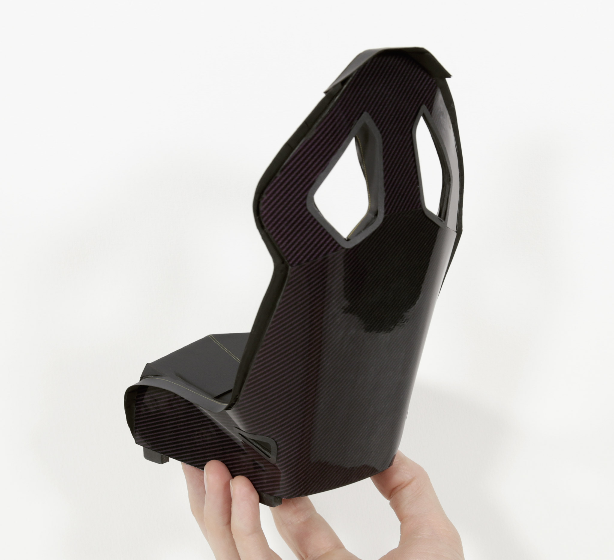 Rear side of one front seat. The rear surface parts of each bucket seat are printed on gloss photo paper, to emulate the look of shiny carbon fibre. Good enough for a few laps of the Nürburgring I reckon.