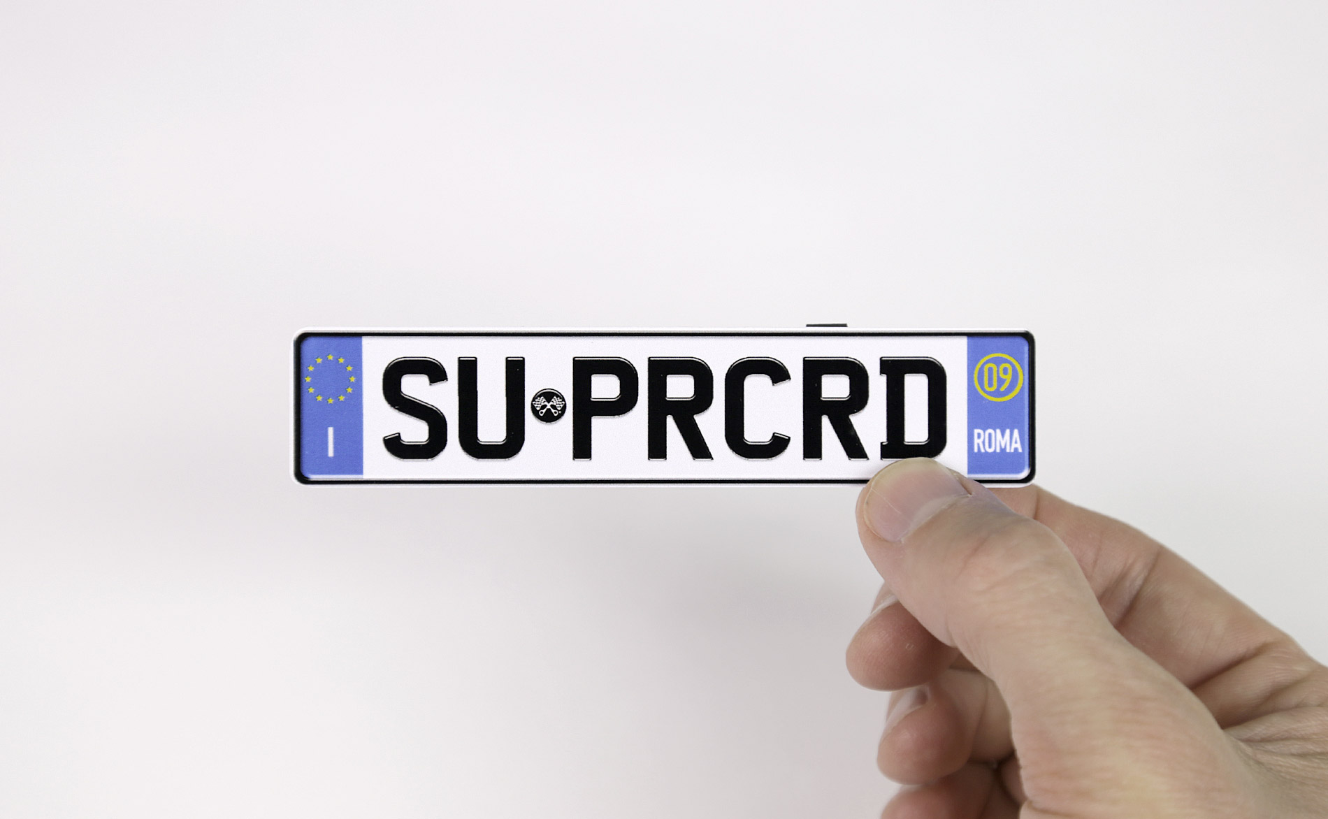 After I designed a custom number plate using Photoshop, I printed it on glossy photo paper, cut it out, then glued to a backing of cardboard. Italian plates for an Italian car.