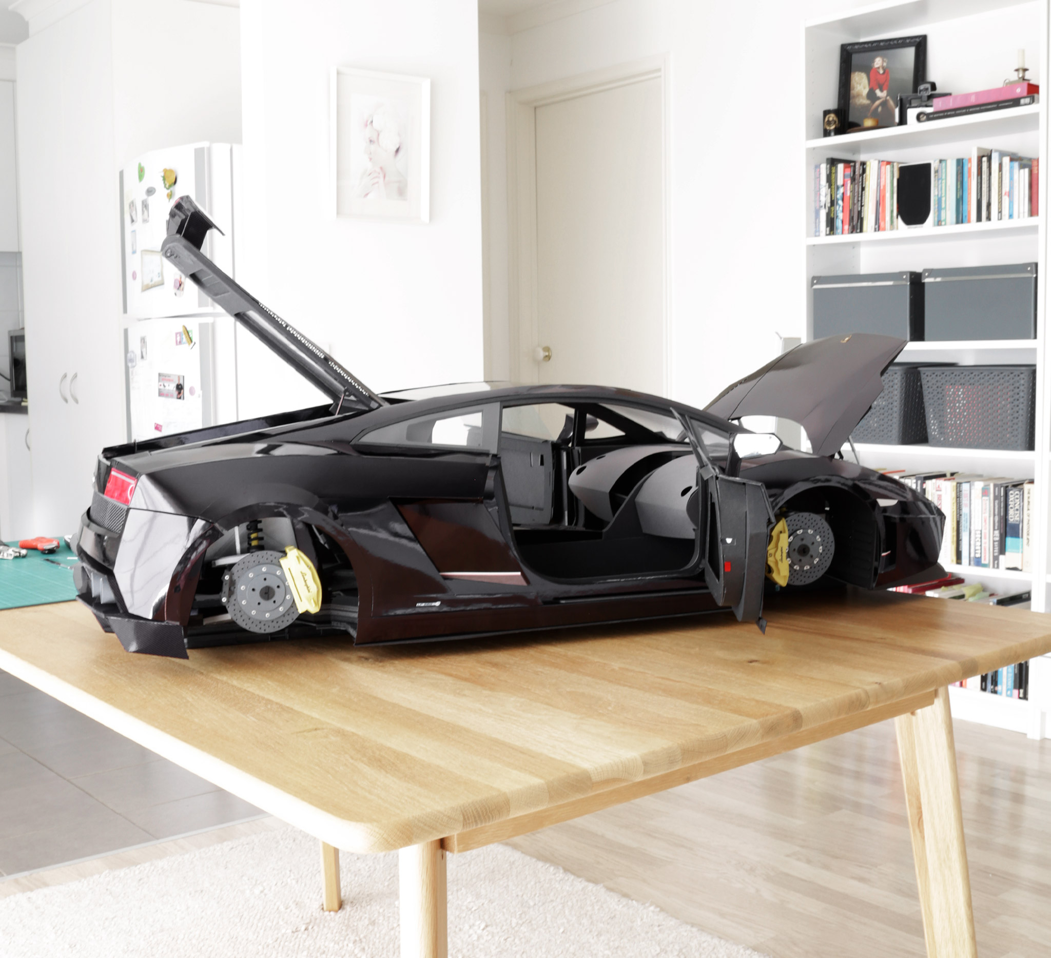 Side-view showing the completed body, with the front trunk lid, doors, and engine cover open.