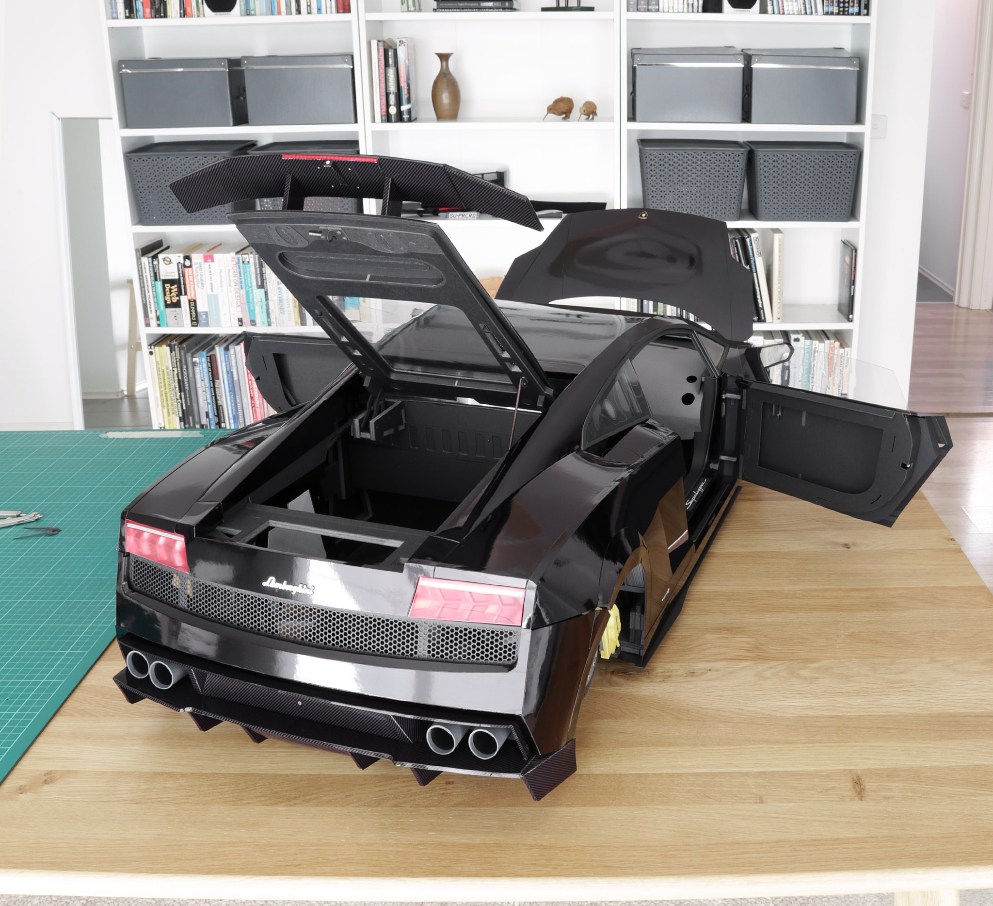 Another angle showing the completed body, with the front trunk lid, doors, and engine cover open.