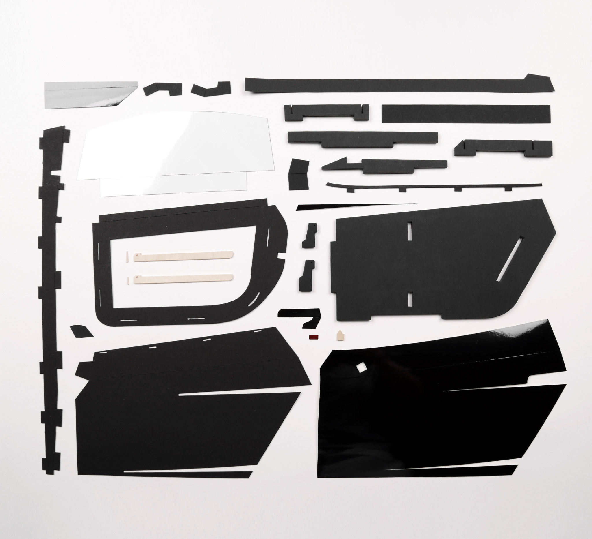 Parts for one of the Gallardo's doors. All cut by hand. Plans for each part are created with Adobe Illustrator.