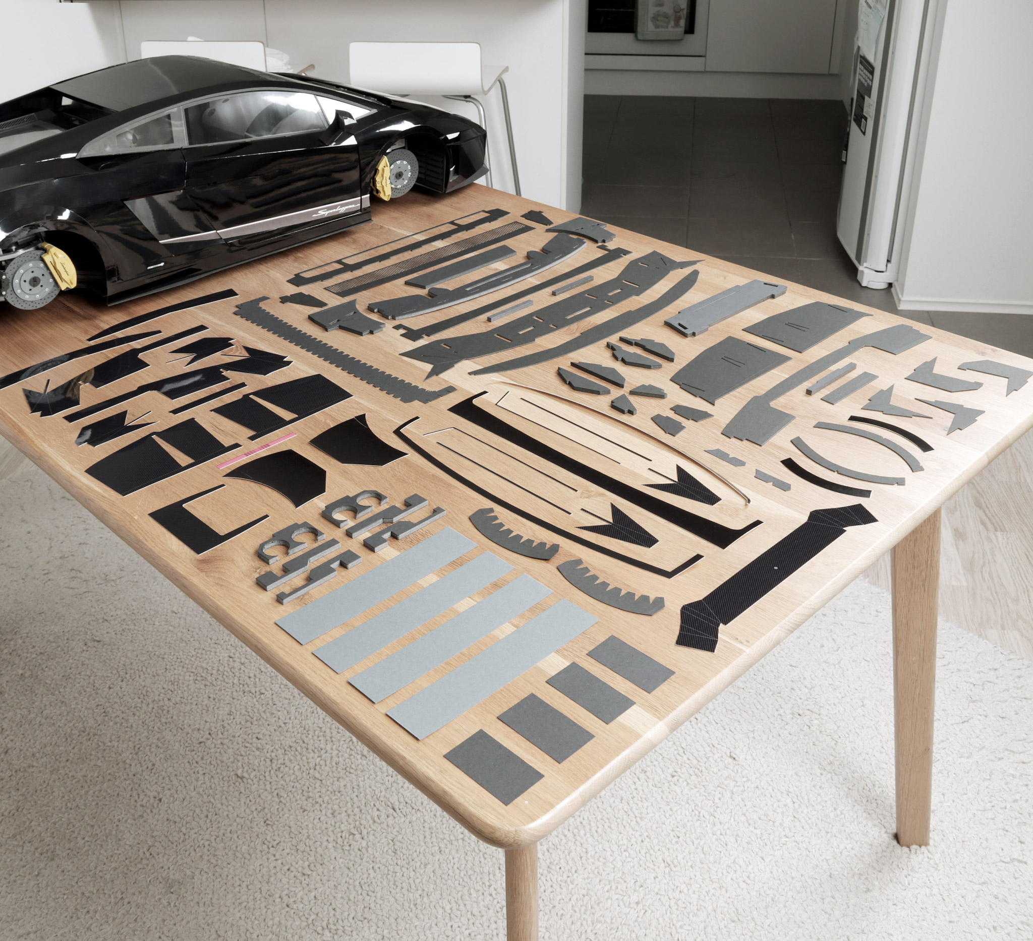 Parts for the rear bumper and exhaust tips, ready to be assembled. There's about 80 individual parts if I include the exhaust tips and mounting brackets. Most of these I cut by hand, except for the main vent grille. My new Cricut Maker cutting machine cut for that for me- thank goodness. All parts are first designed by hand and drawn in Adobe Illustrator.